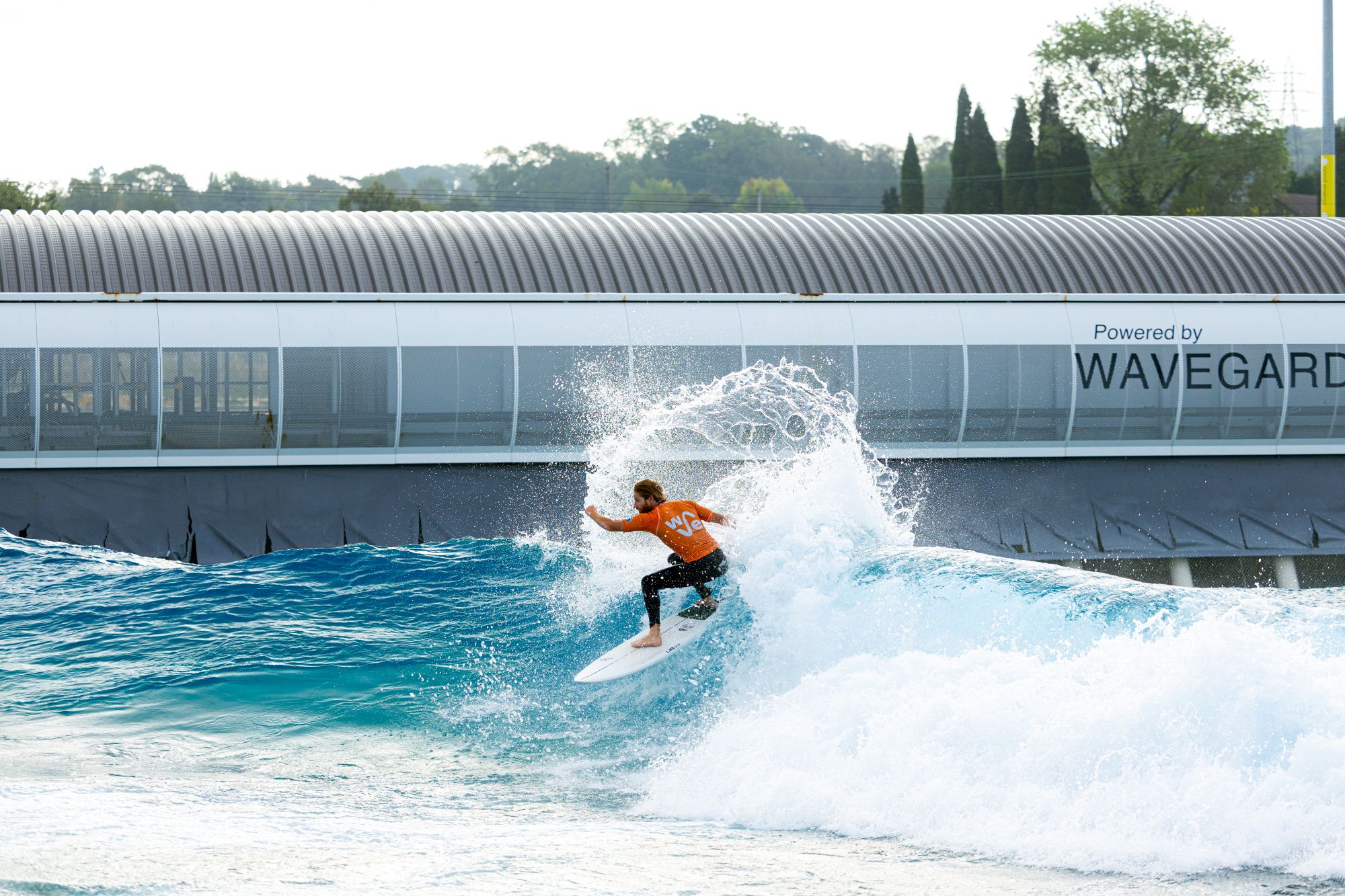 A male surfer rides the Advanced Plus wave.