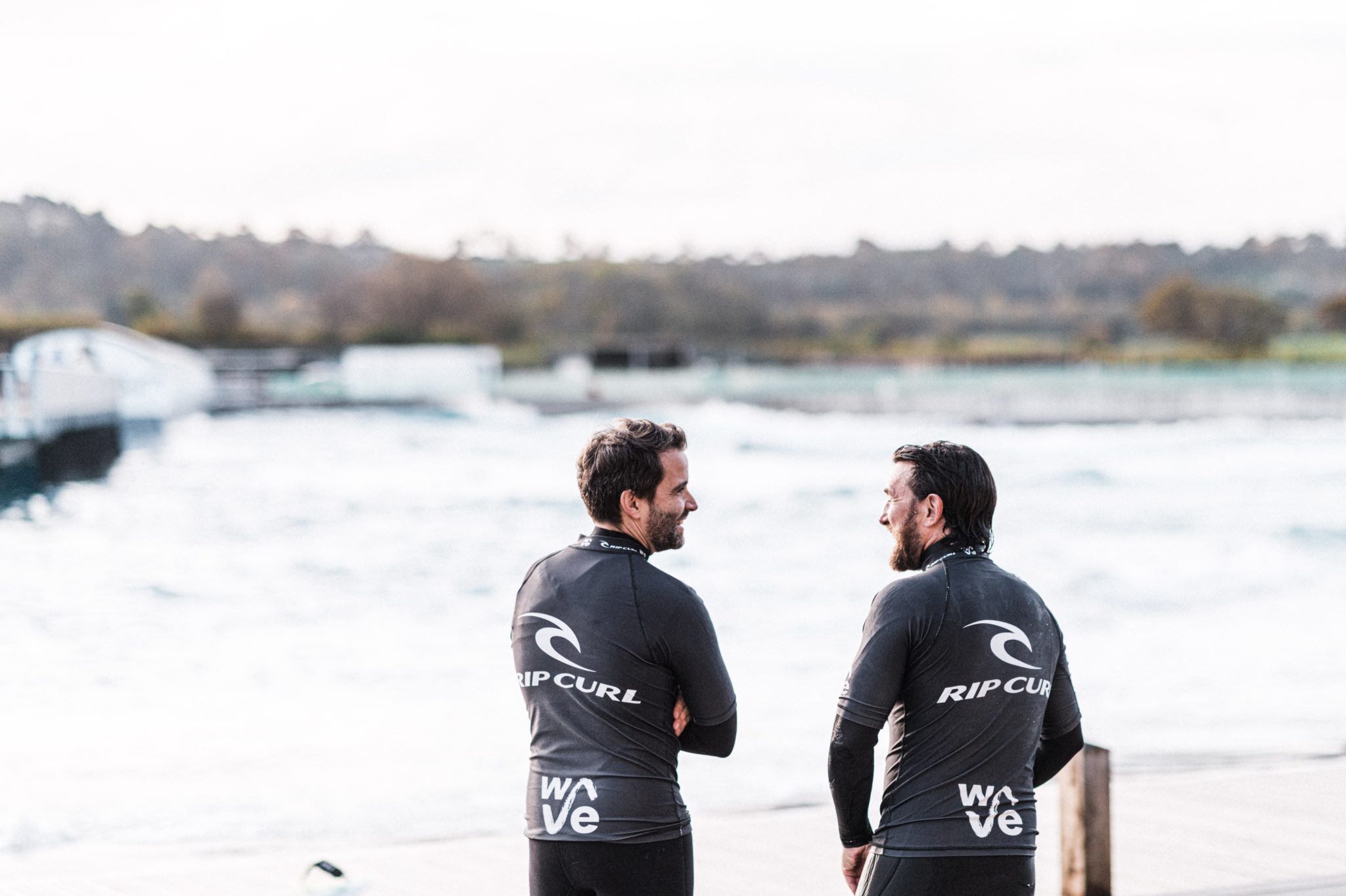 Two adult surfers having a chat after their surf session at The Wave near Bristol