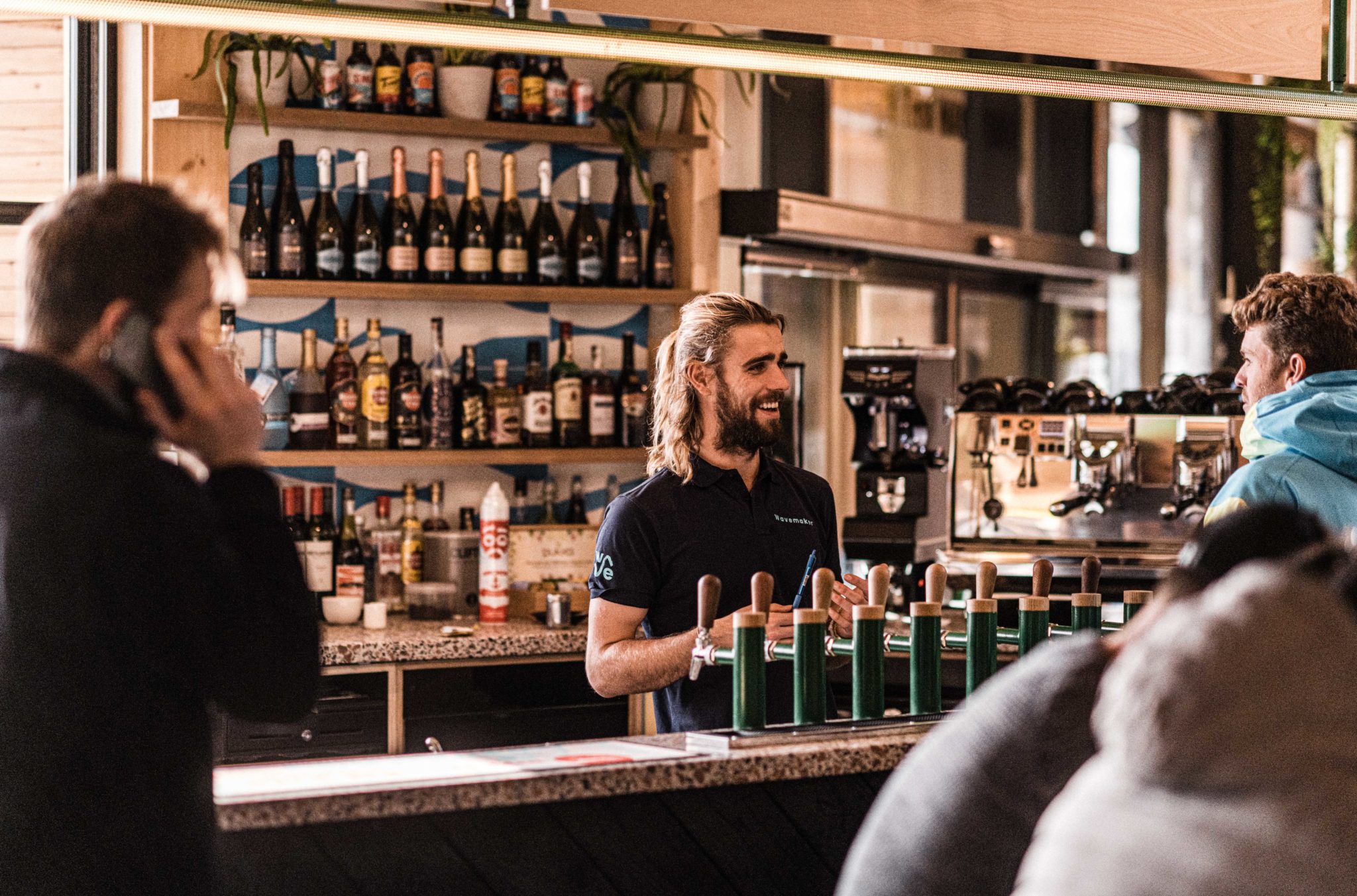 Bartender serving a customer at the bar at the Wave in Bristol