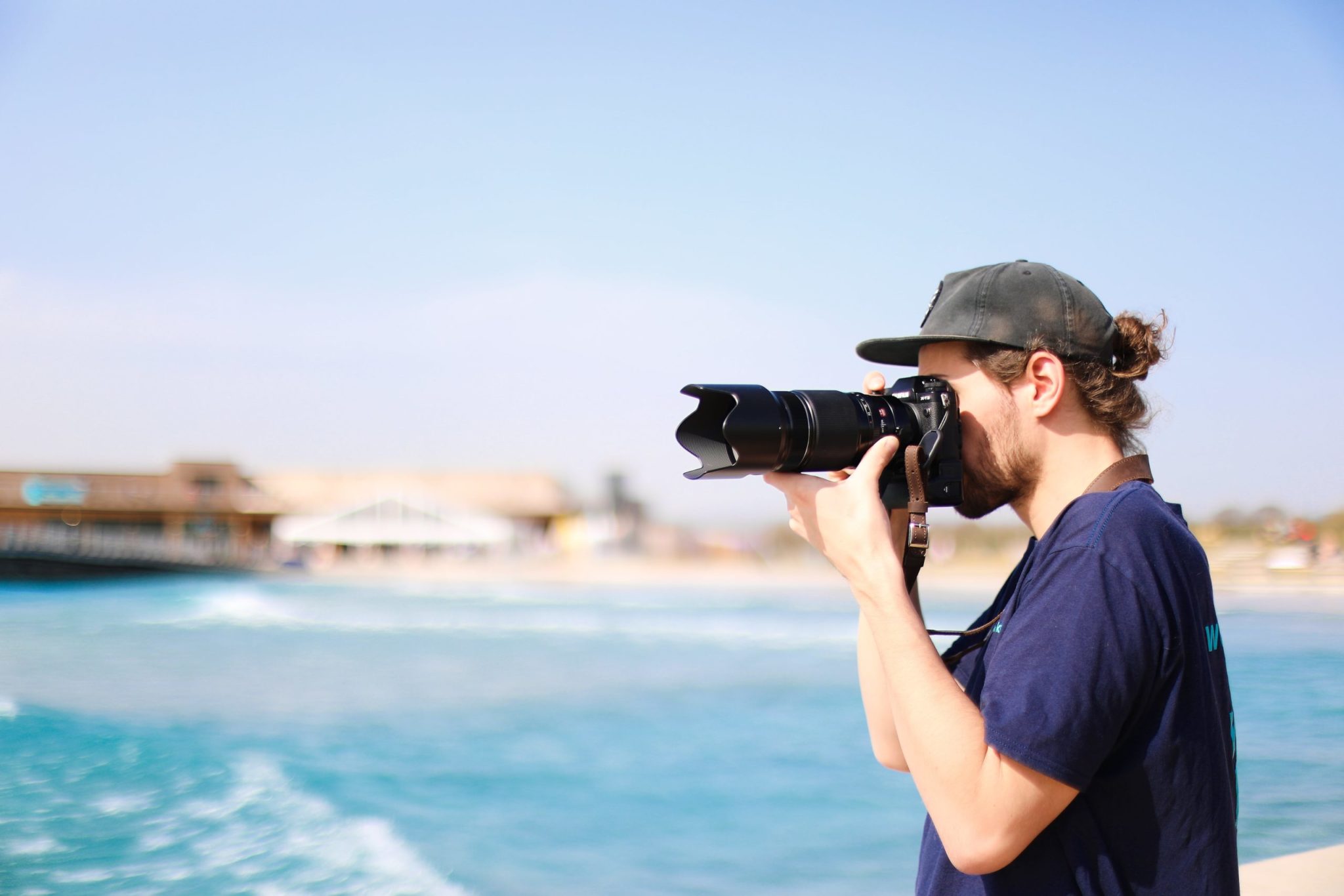Man taking photographs of surfers at The Wave in Bristol