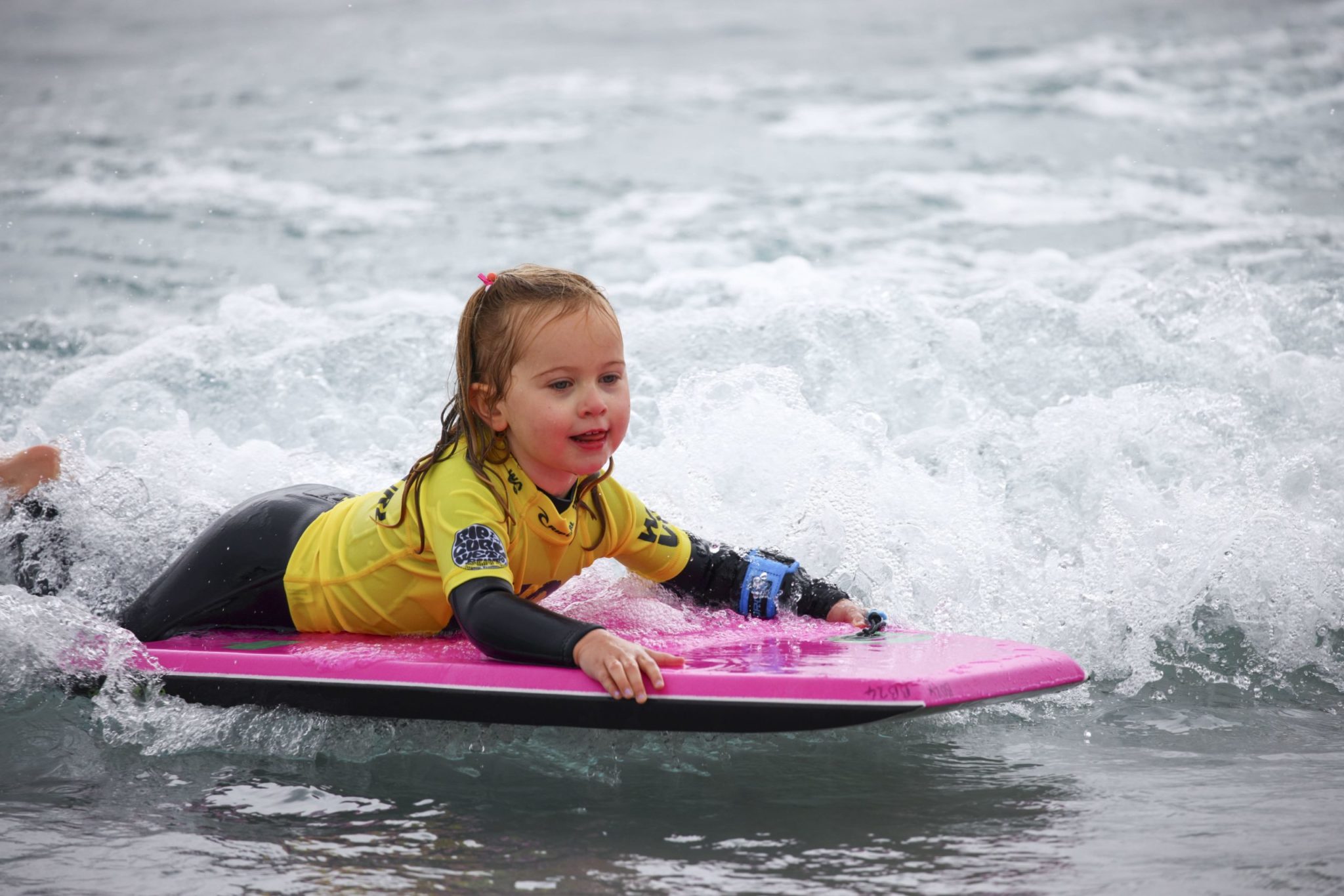 A child on a bodyboard in the bay at The Wave Bristol