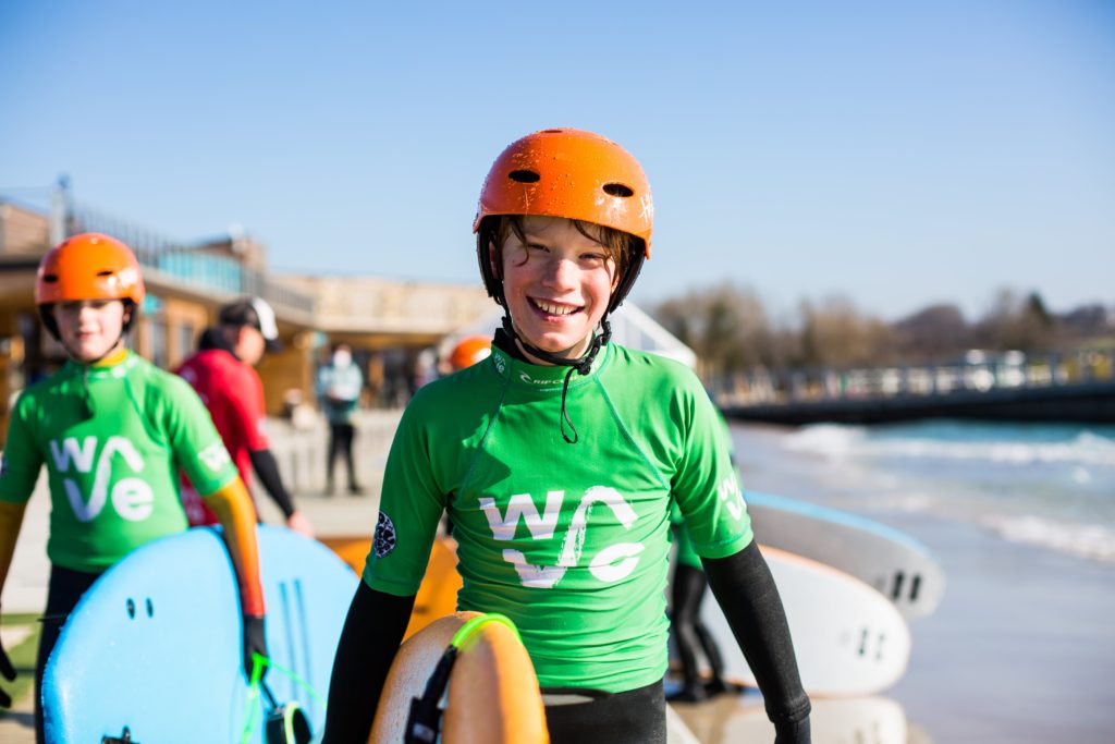 Boy learns to surf at The Wave inlands surf lake near Bristol