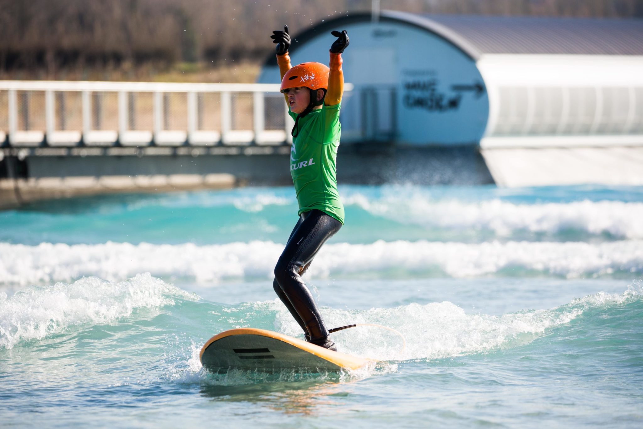 Boy having a good time surfing at the Wave near Bristol