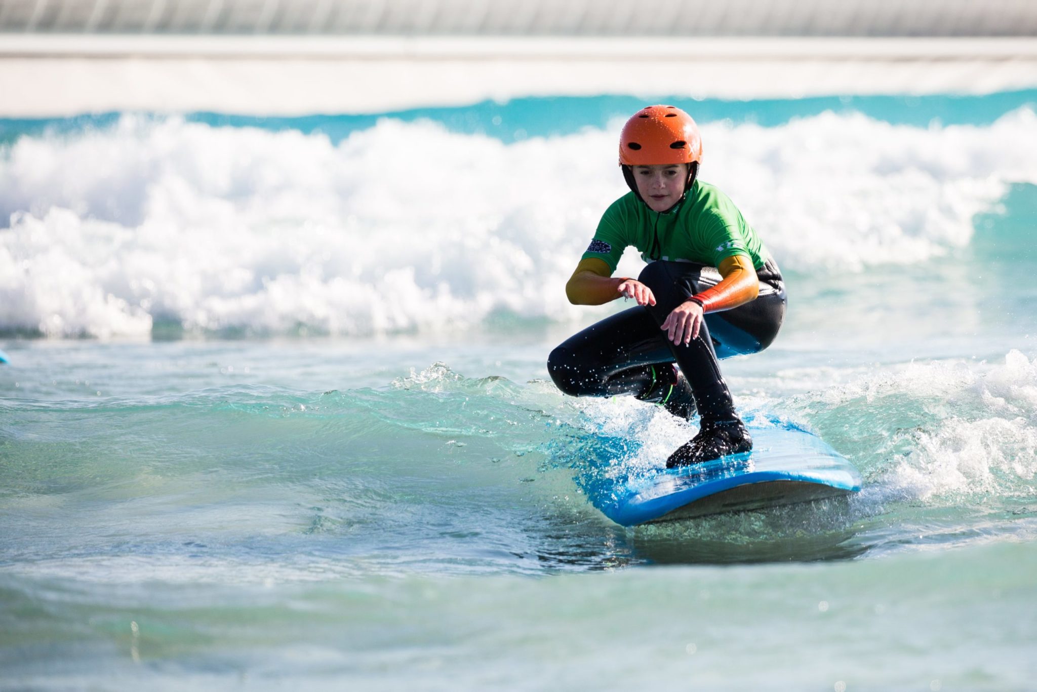 Boy learning to surf at the Wave surfing inland lake near Bristol
