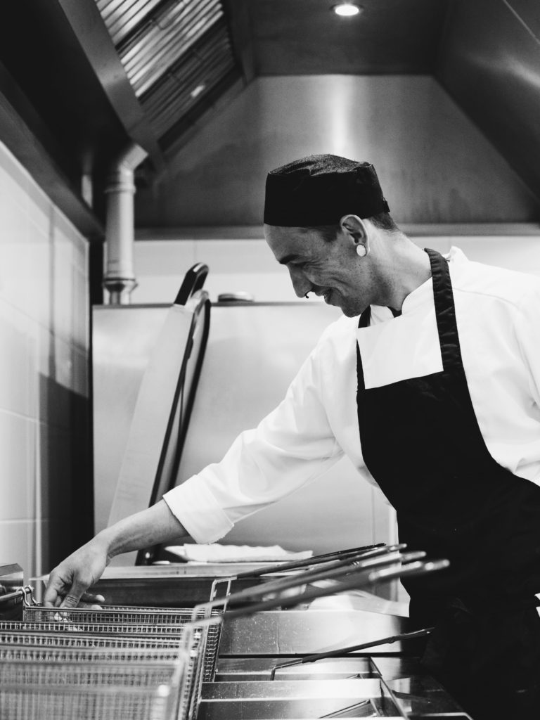 Chef smiling at Wave restaurant near Bristol in black and white