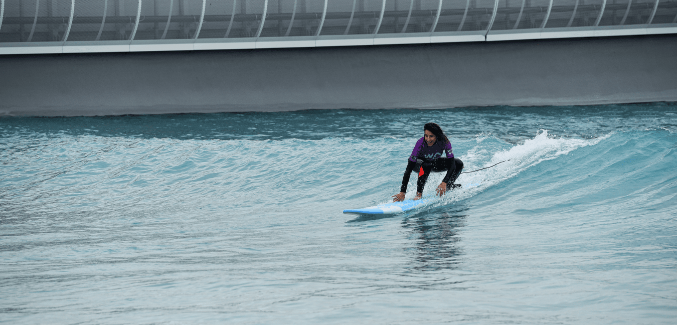 Woman riding first green waves at the Wave in Bristol