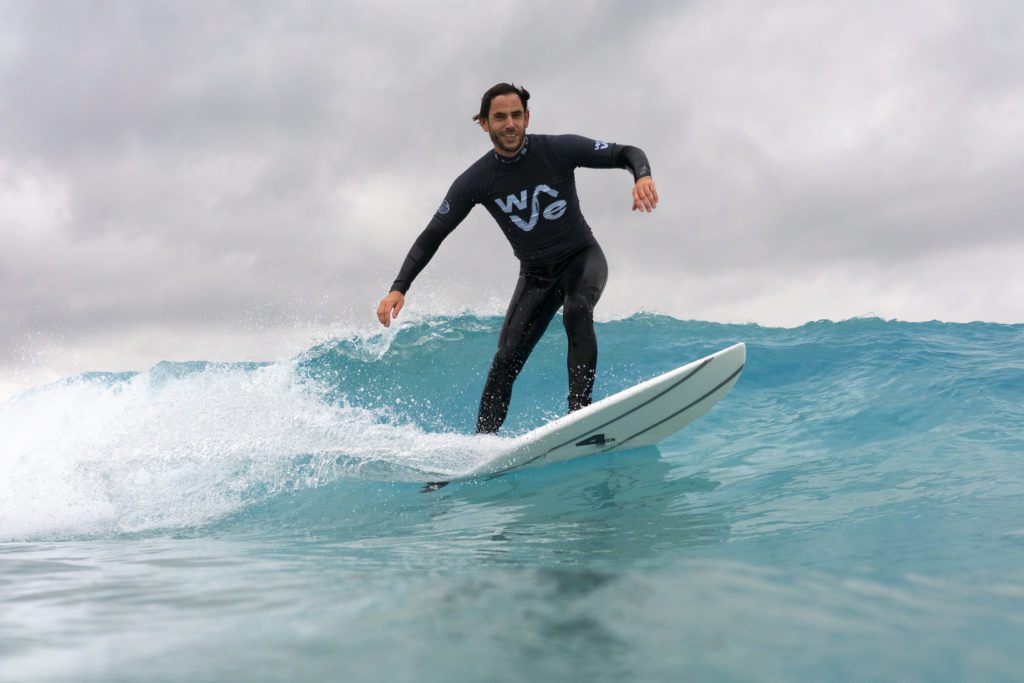 Surfer riding waves at inland surfing lake The Wave near Bristol