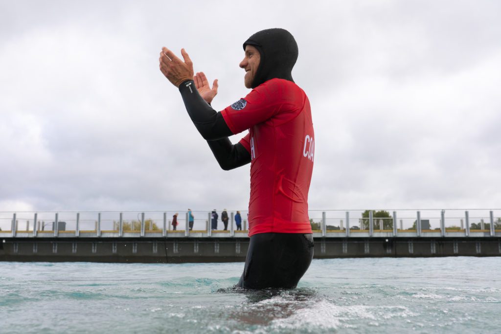 Surf coach cheering up the class at The Wave inland surfing lake near Bristol