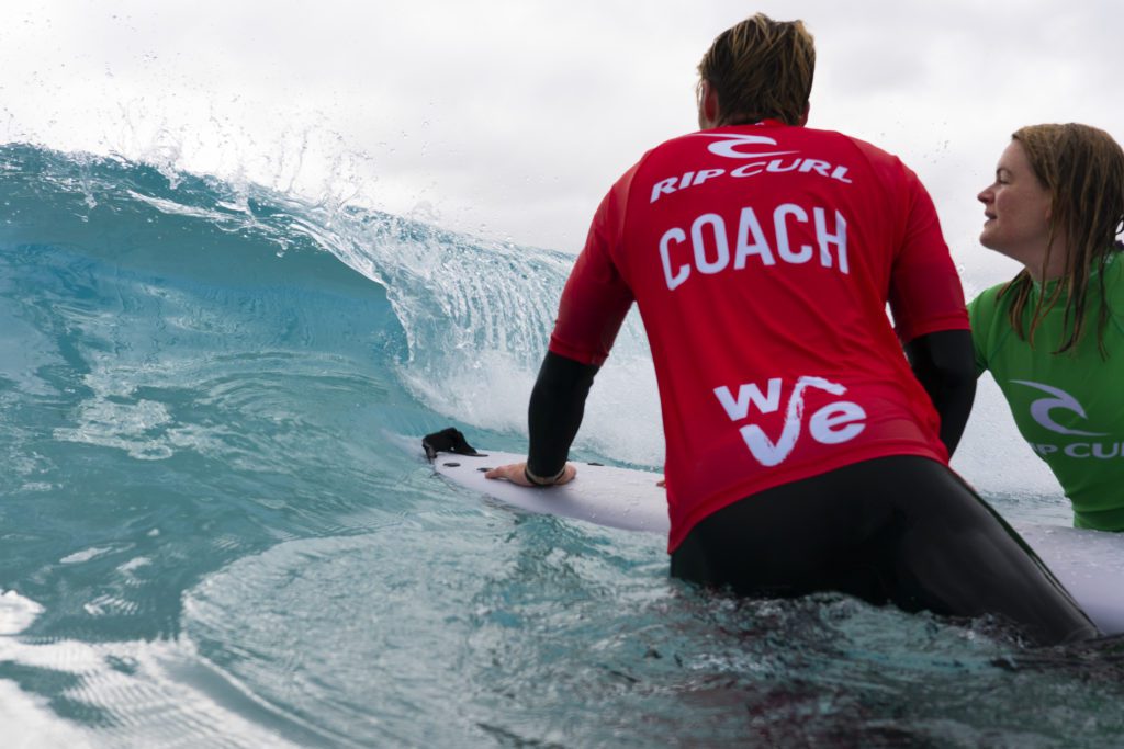 Surf coach teaching a girl how to surf at inland surfing lake The Wave near Bristol