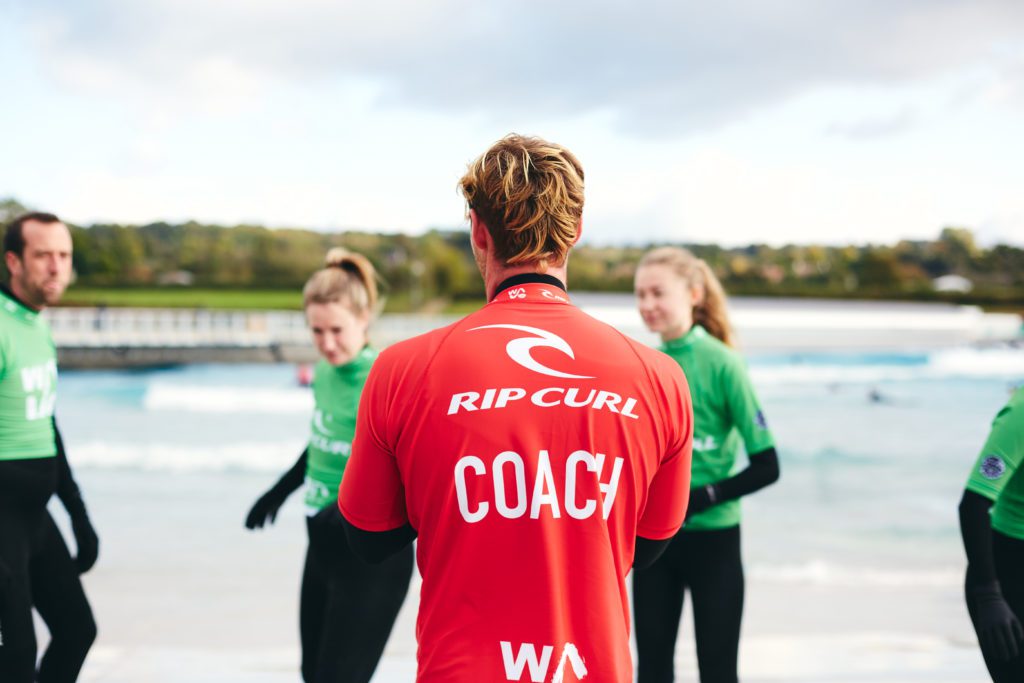 Coach giving instructions before starting the surf class at the Wave near Bristol