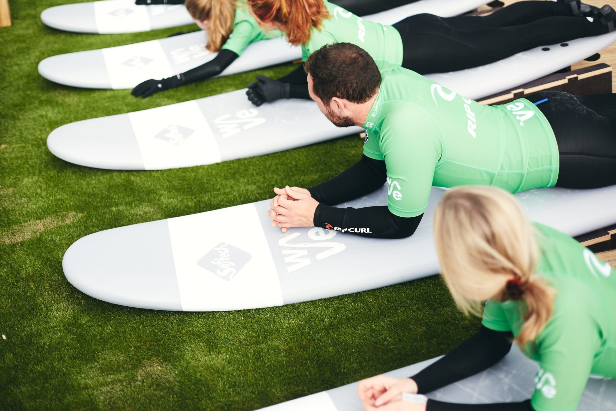 Group learn to surf at The Wave inland surf lake near Bristol