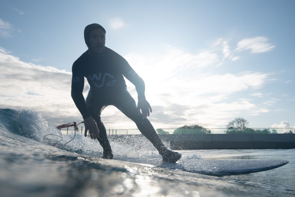 Man green wave surfing at The Wave in Bristol