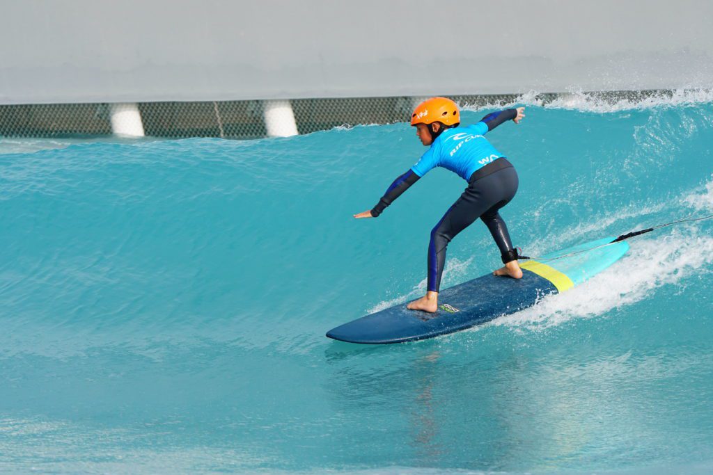 Kid surfing at The Wave, inland surfing lake near Bristol