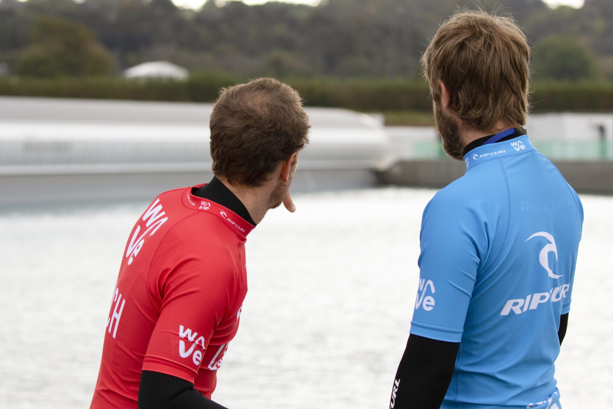 Surf coach giving instructions on how to catch a wave at surfing inland lake The Wave in Bristol