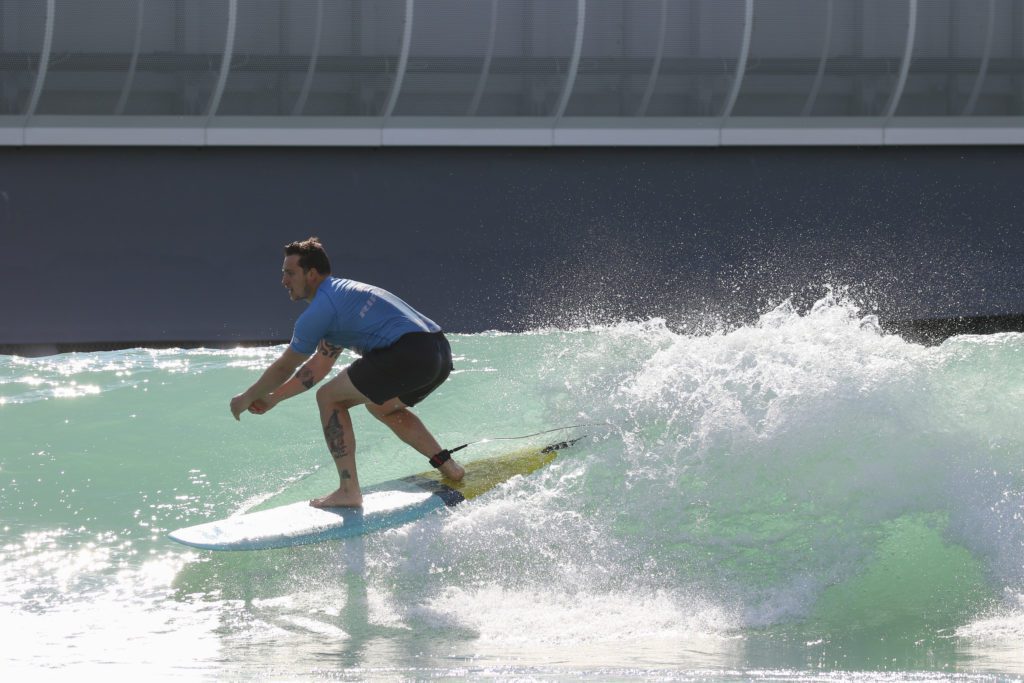 Man surfing during Summer at The Wave, surfing inland lake near Bristol