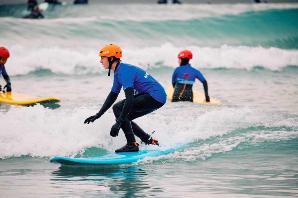 Boy learns to surf at The Wave inland surf lake near Bristol