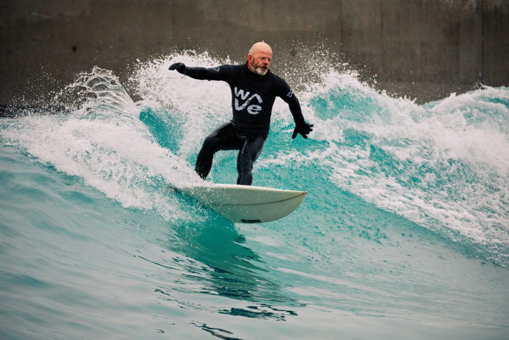 Surfer turning waves during winter at The Wave, surfing inland lake in Bristol
