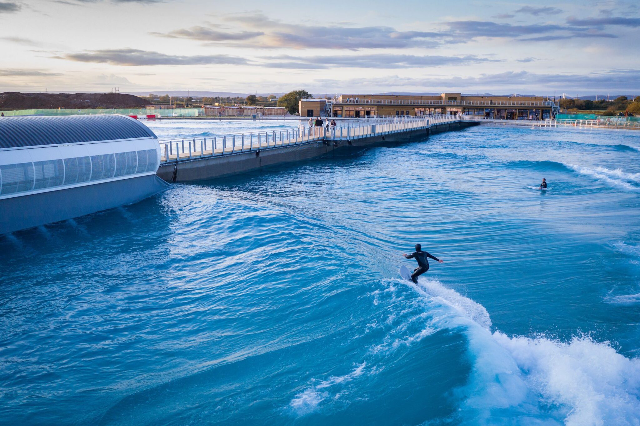 A surfer riding a wave at The Wave, inland surfing lake near Bristol
