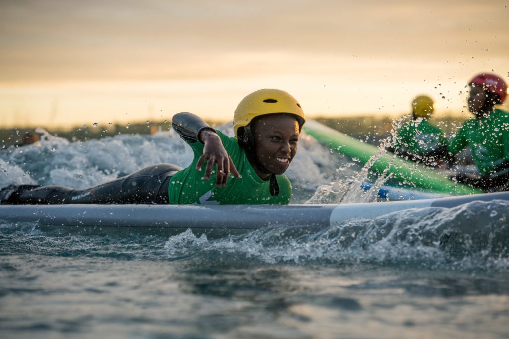 A boy learning to surf in a Beginner Lesson at The Wave near Bristol