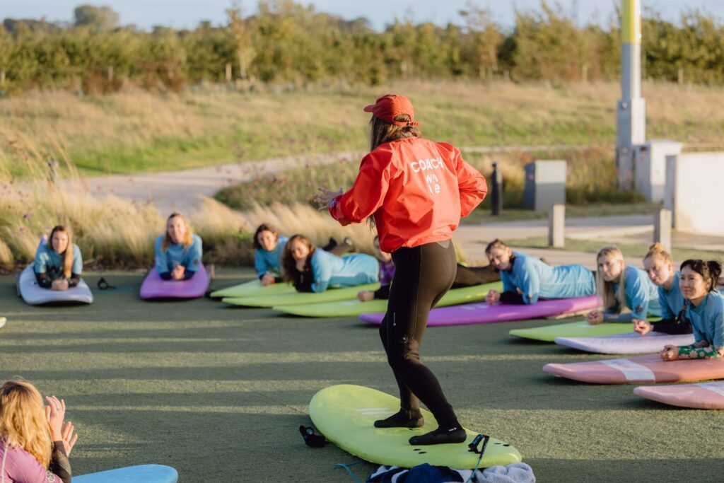 A female coach leads a women's only surf lesson at The Wave Bristol