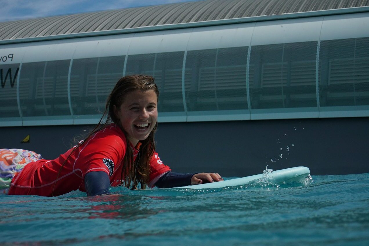 Woman paddling out on Sister Session day
