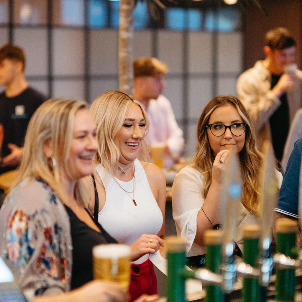 People enjoying a drink at the bar in the clubhouse at The Wave near Bristol