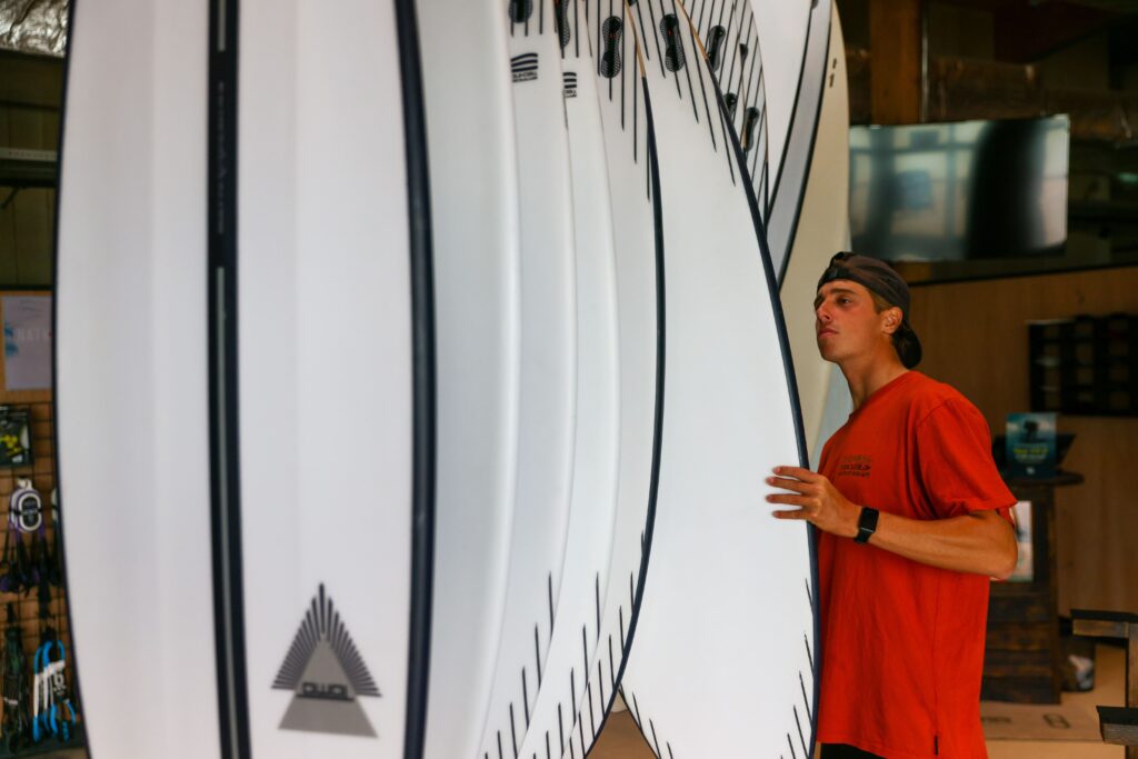 Customer browsing surfboards in the Boardroom at The Wave