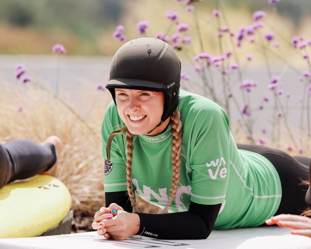 A learner surfer takes a beginner lesson at The Wave Bristol