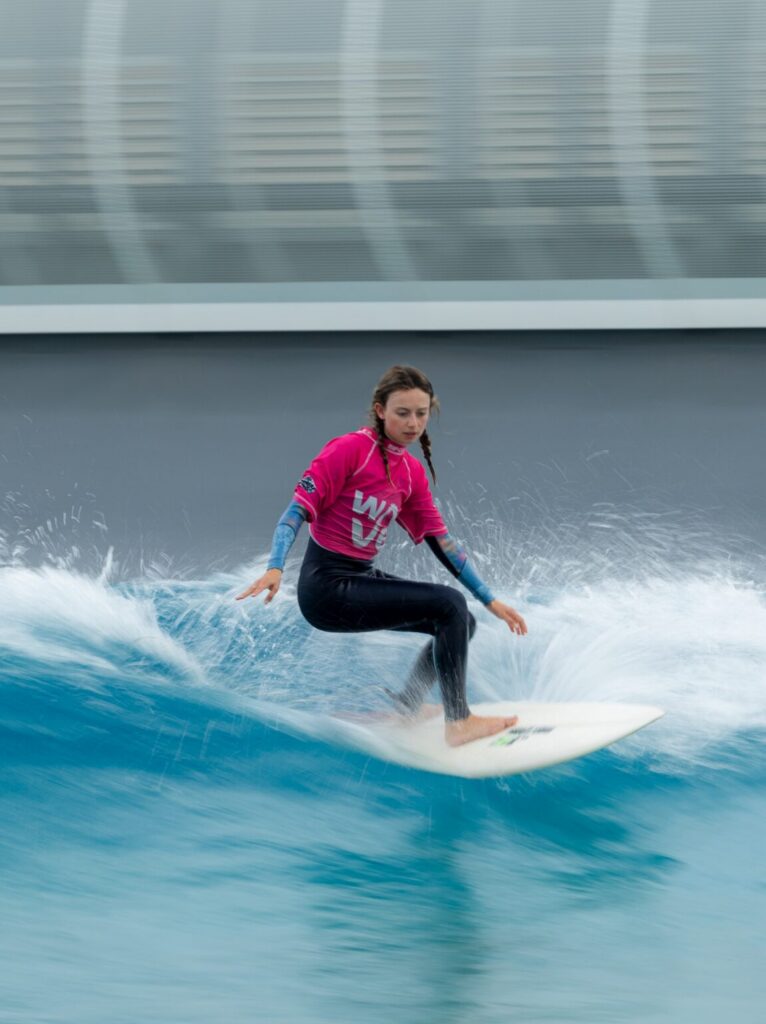 A female surfer rides the Advanced wave at The Wave Bristol.