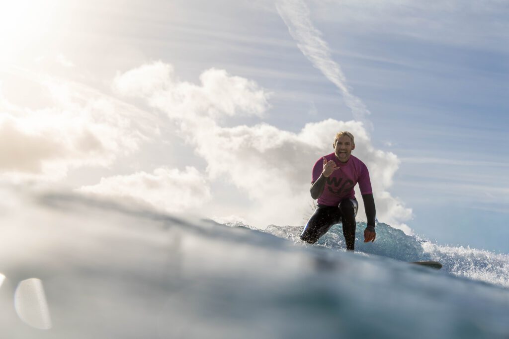 Big wave surfer smiles at the camera at The Wave in Bristol.