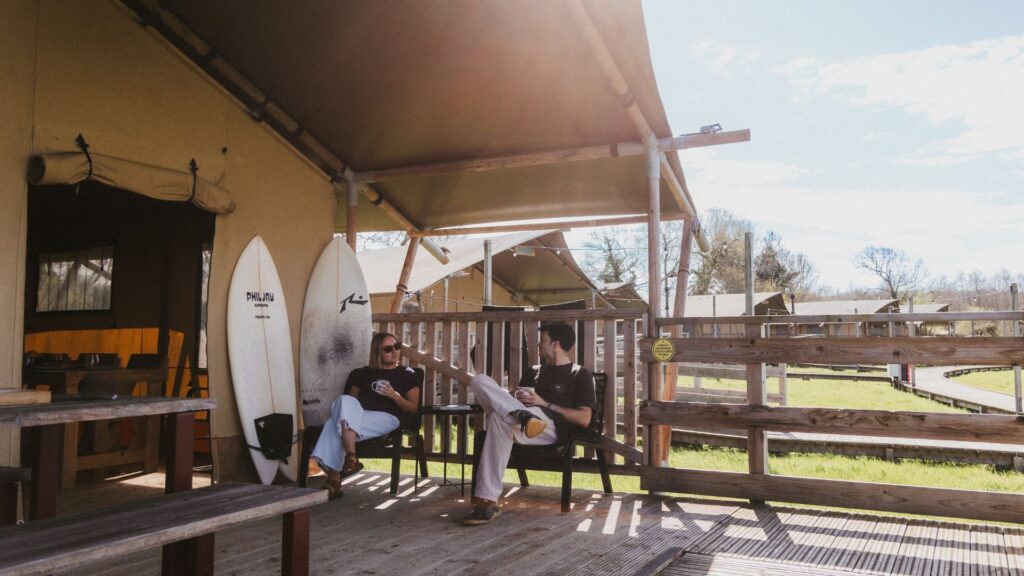 surfers sat outside safari tent at The Camp at The Wave Bristol