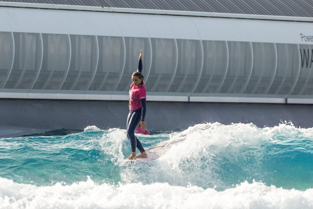 Surfer on surfboard at wave pool in Bristol