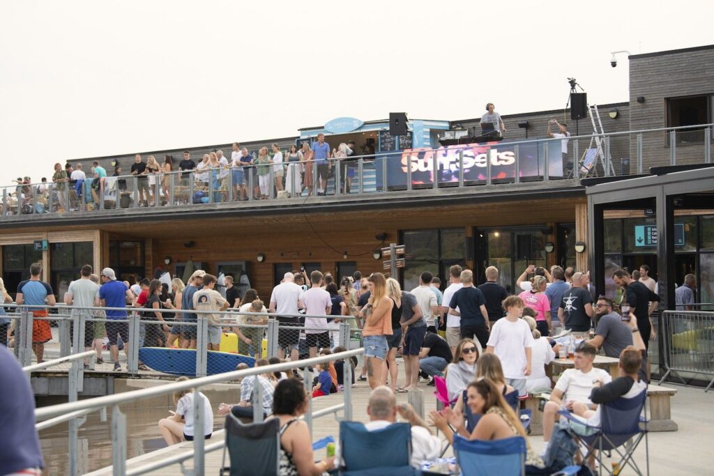 Event at The Wave with DJ on the balcony and crowd listening