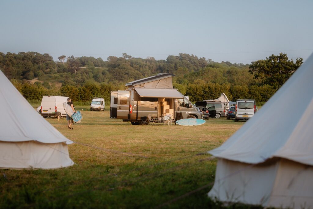 Surfer walking to his Sunlife campervan in The Field at The Wave Bristol