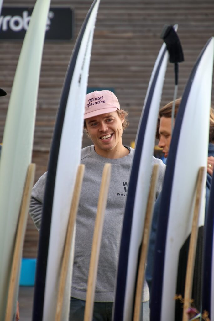 Member of The Wave's staff with rack of boards