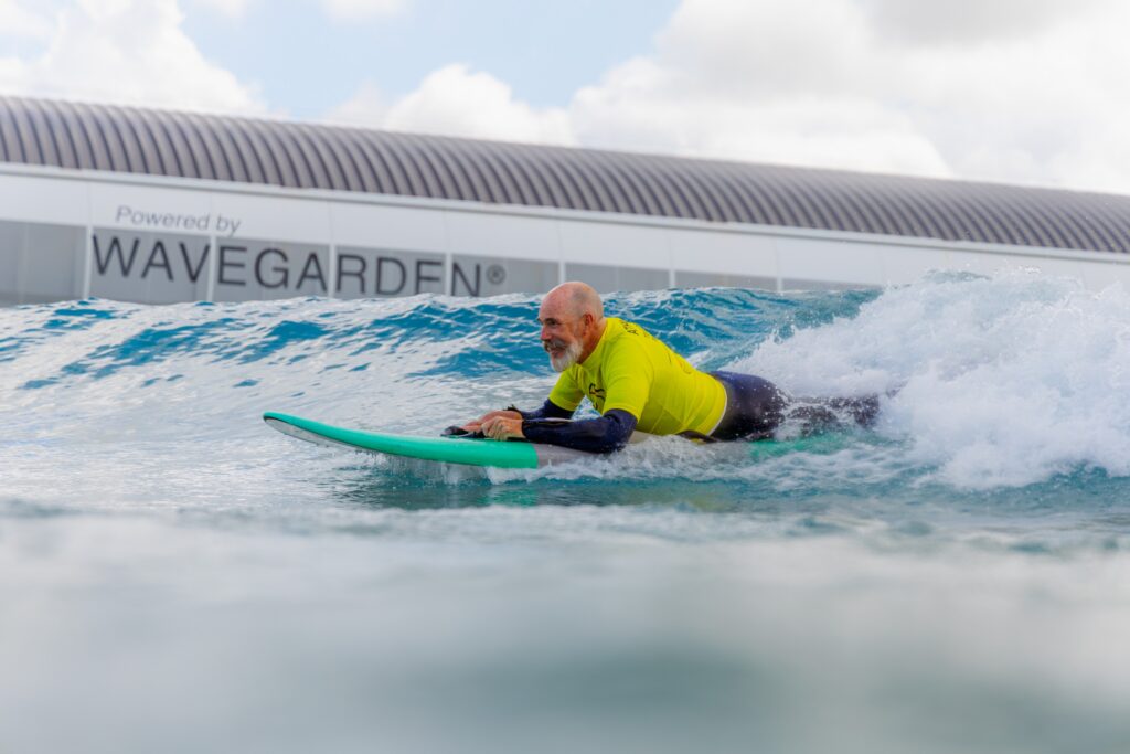 Adaptive surfer riding a wave at The Wave Bristol during the Para Surfing Roadshow