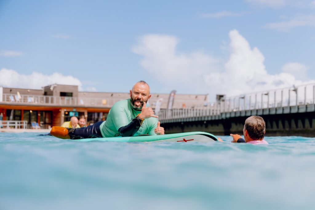 Adaptive surfer riding a wave at The Wave Bristol during the Para Surfing Roadshow