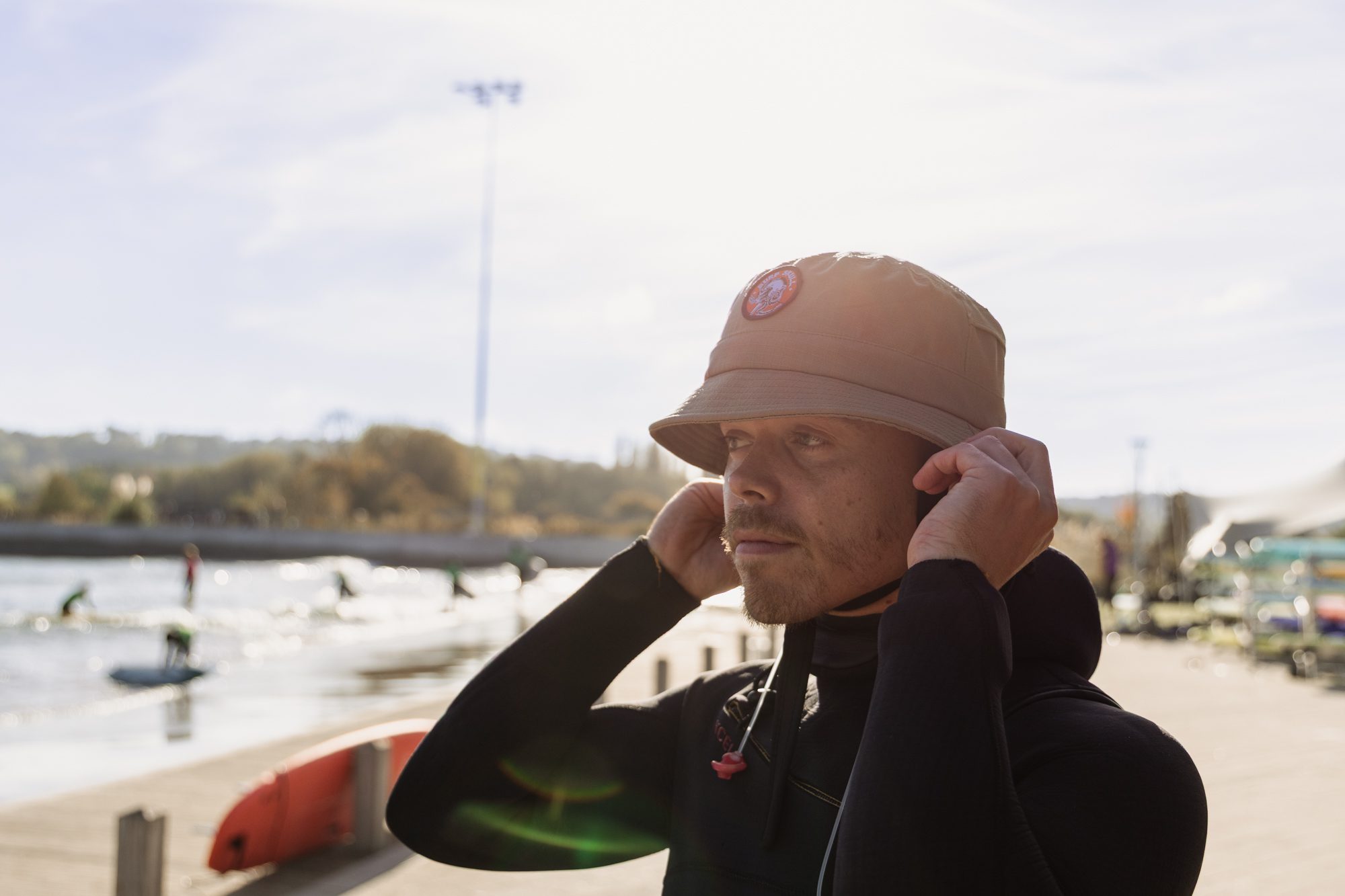 Surfer wearing bucket hat surf helmet