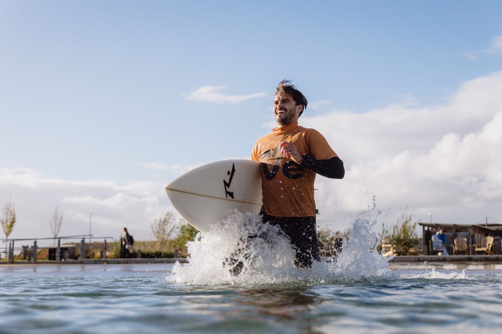 Surfer Archie running into the lake